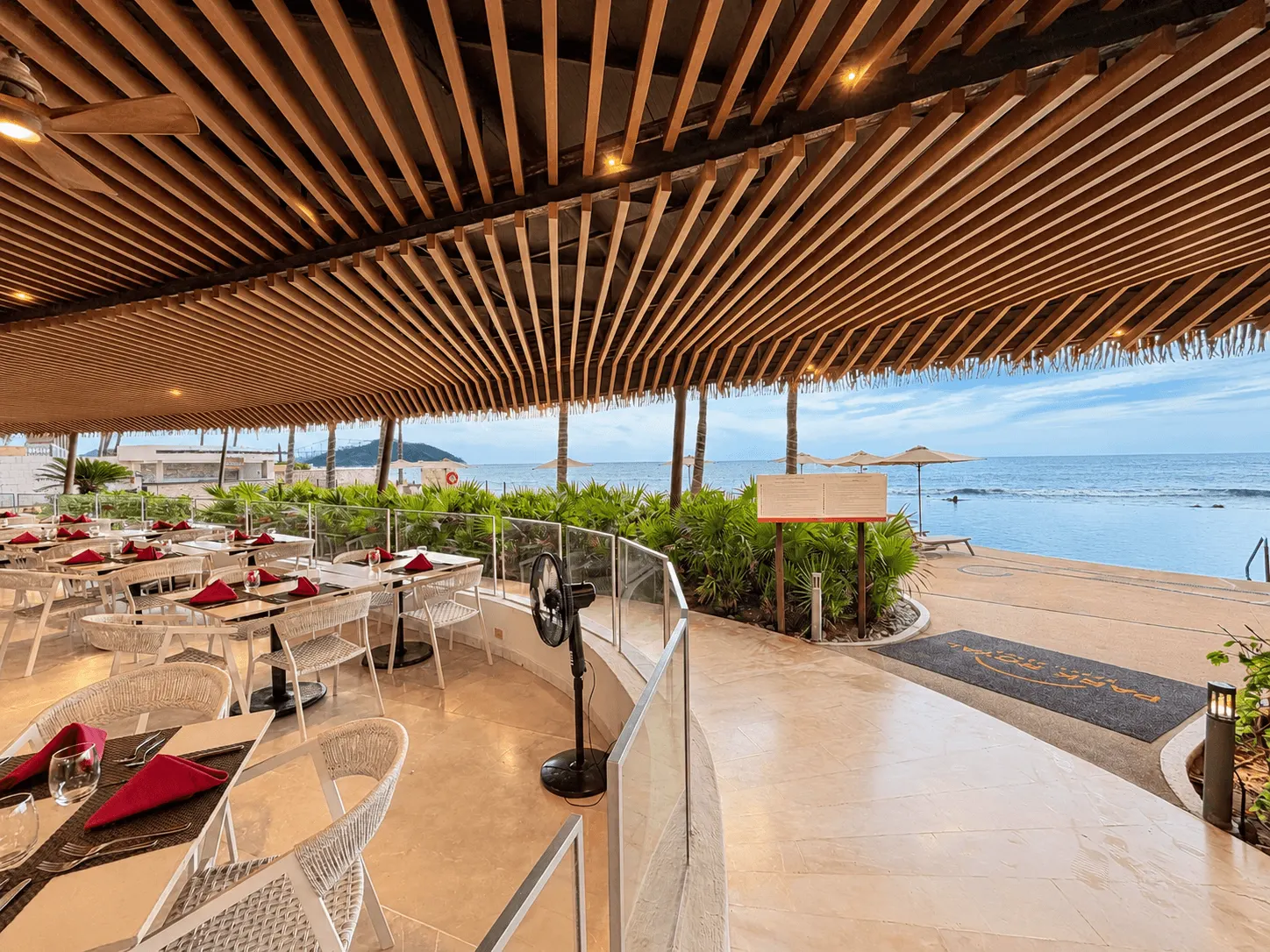 departamento-park-royal-mazatlan-cerritos-vista-al-mar-playa17 Restaurante con terraza abierta frente a la playa y techo de madera en el edificio Park Royal Mazatlán